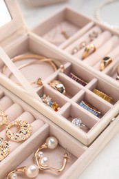 Photo of Jewelry box with stylish golden bijouterie on white table