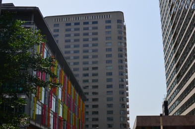 Exterior of beautiful modern skyscraper against blue sky