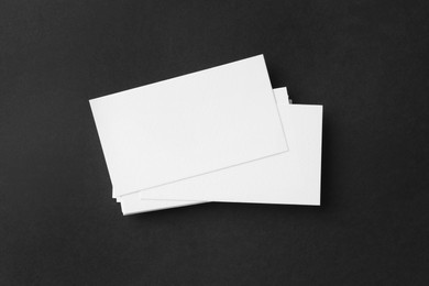 Photo of Blank business cards on black background, top view. Mockup for design