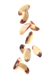Delicious Brazil nuts falling on white background 