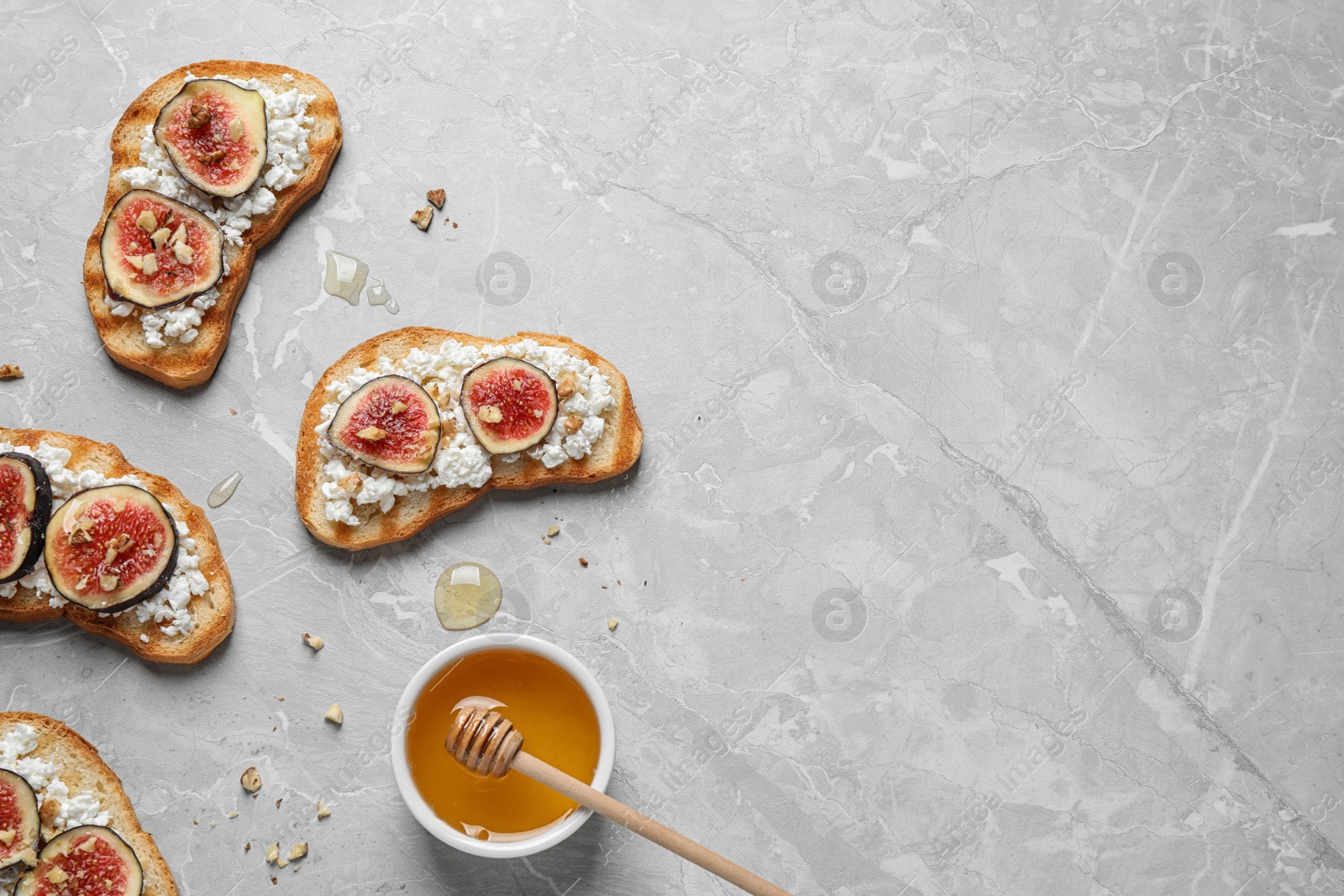 Photo of Bruschettas with cheese and figs on marble table, flat lay. Space for text