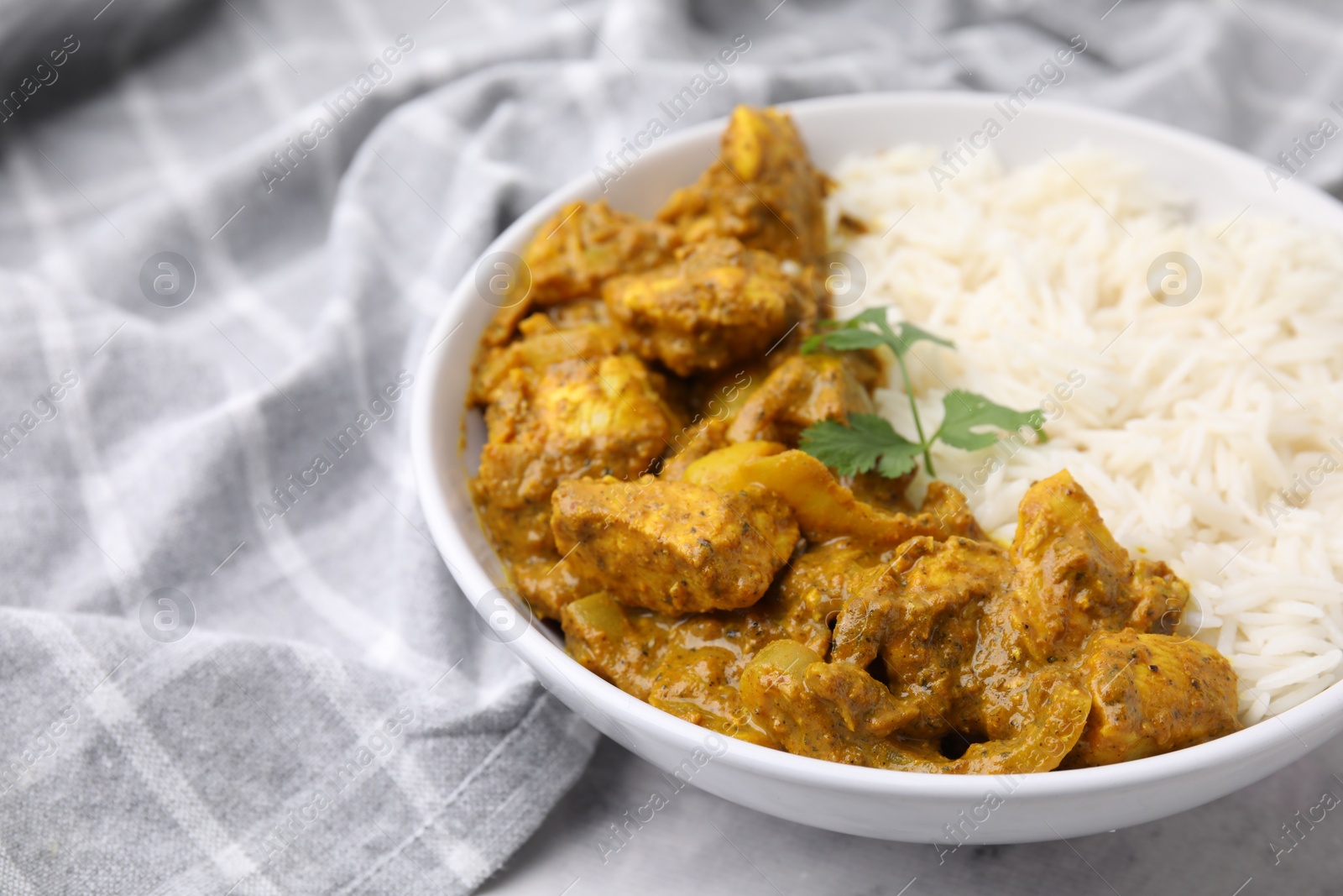 Photo of Delicious chicken curry with rice on table, closeup