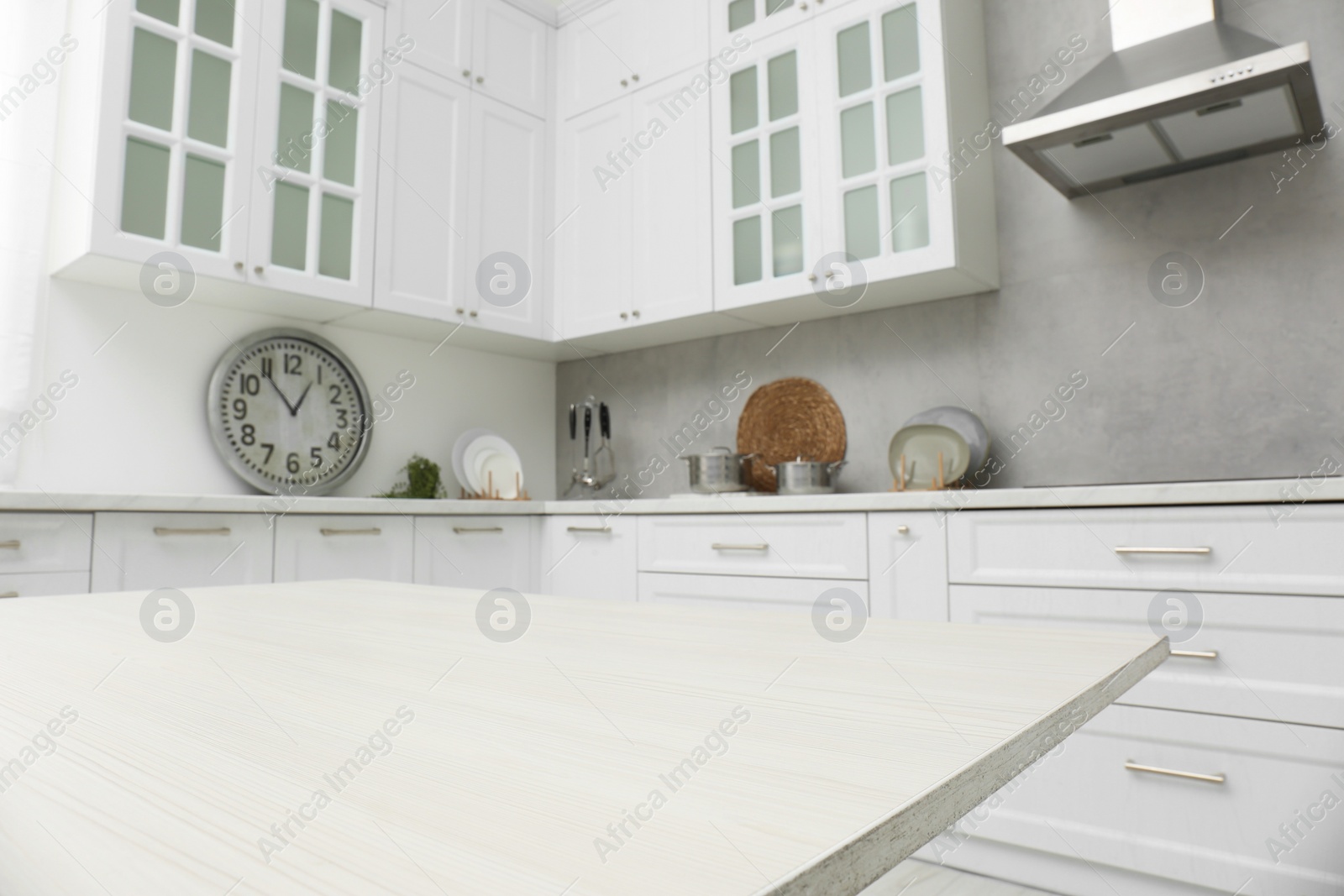 Photo of White wooden table in kitchen, closeup. Interior design