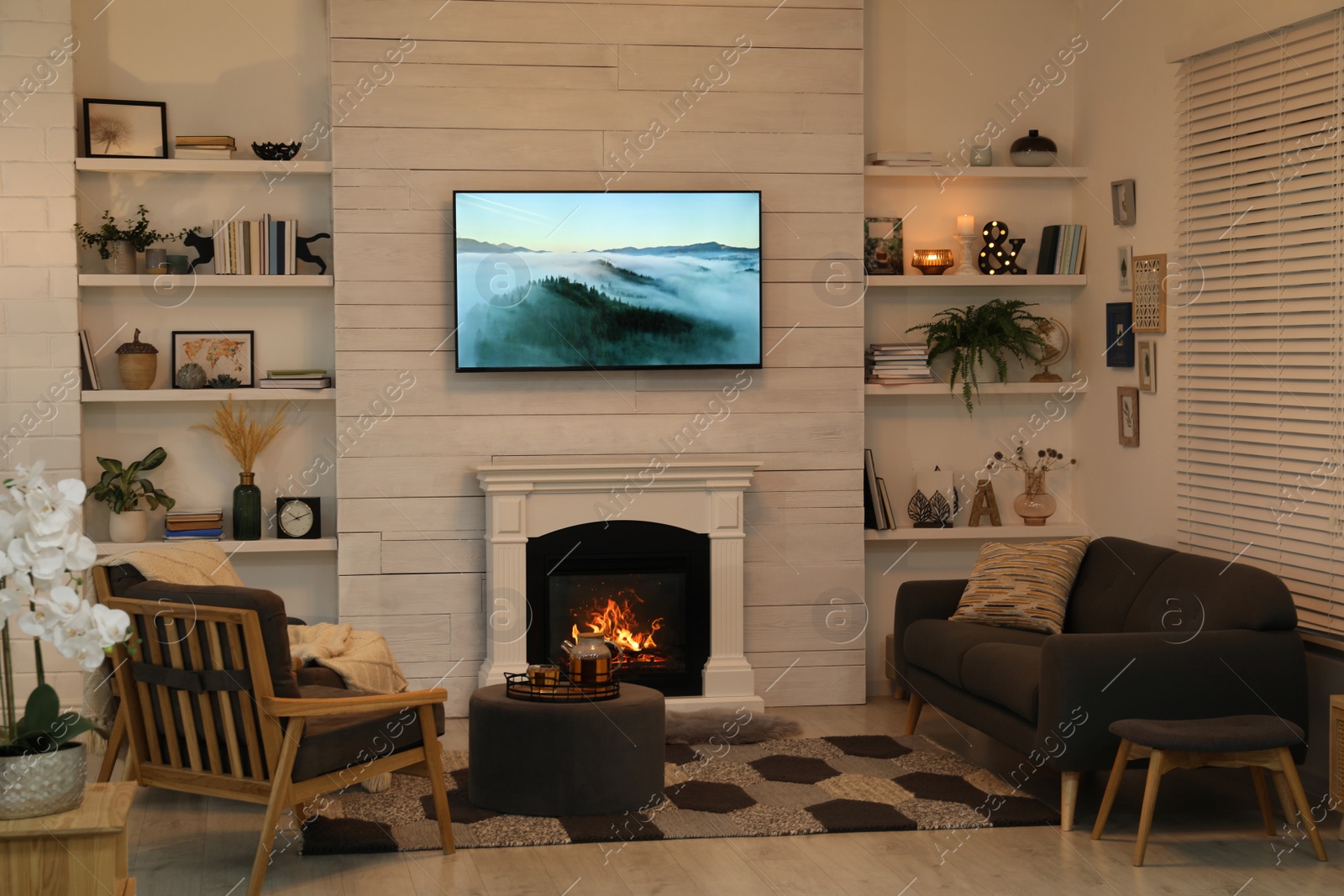 Photo of Cozy living room interior with comfortable sofa, armchairs and decorative fireplace