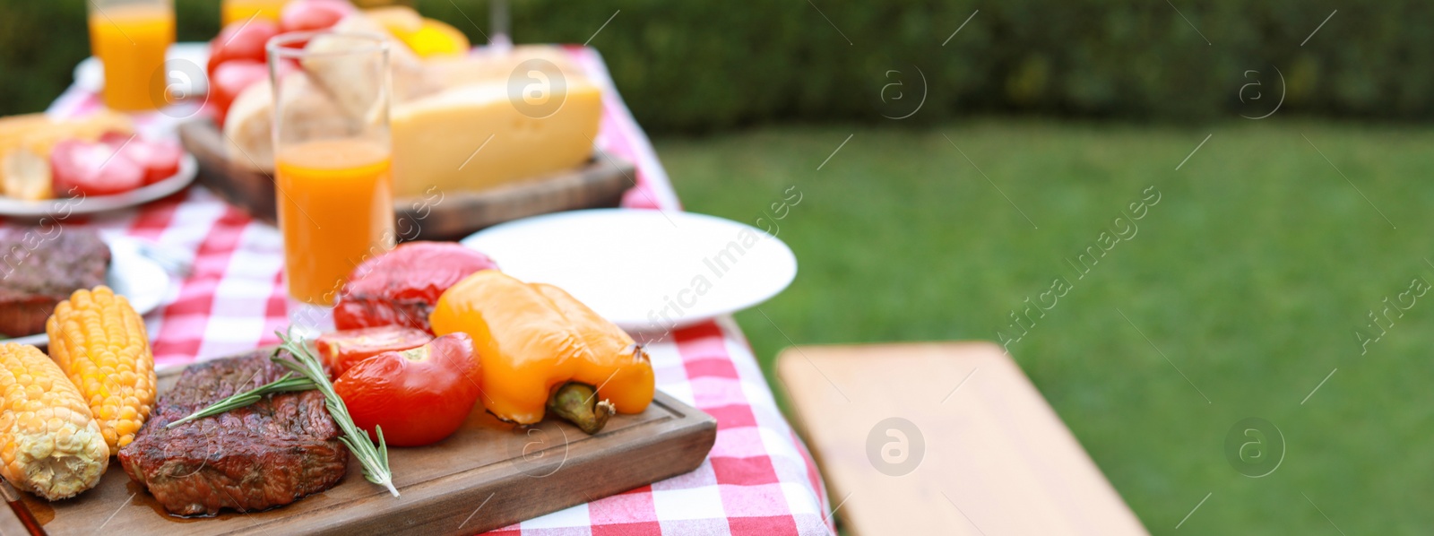 Image of Table with delicious food and drinks outdoors, closeup view with space for text. Banner design