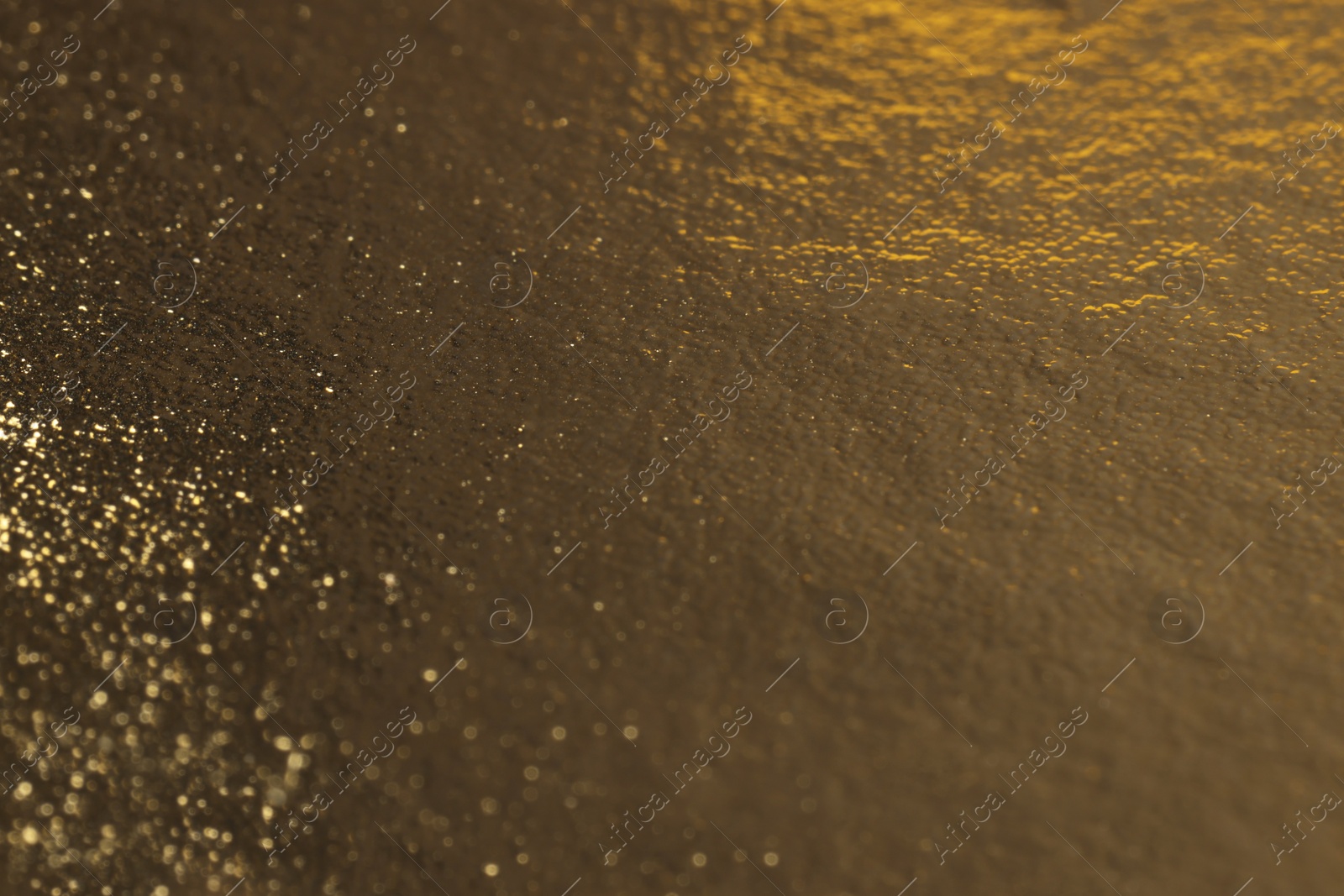 Photo of Edible gold leaf sheet as background, closeup