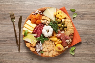 Photo of Different tasty appetizers on wooden table, flat lay