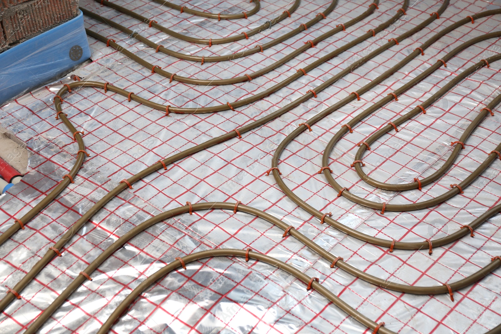 Photo of Installation of underfloor heating system in building