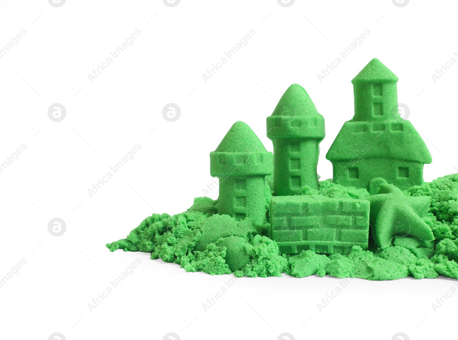 Photo of Castle figures and starfish made of green kinetic sand isolated on white