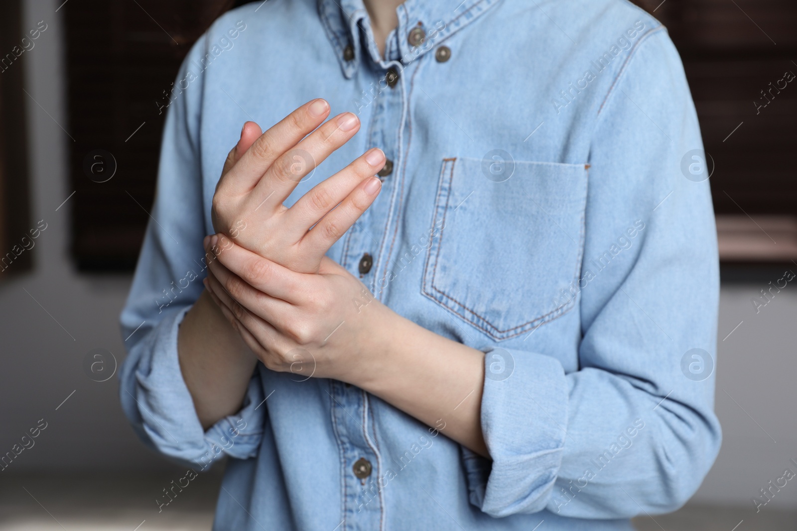 Photo of Woman suffering from trigger finger at home, closeup