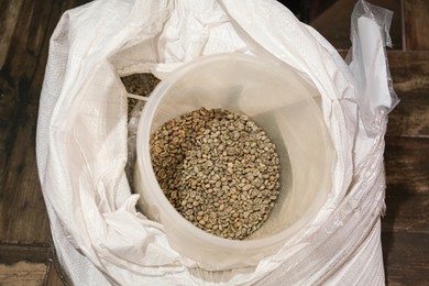 Photo of Raw coffee beans in sack, above view