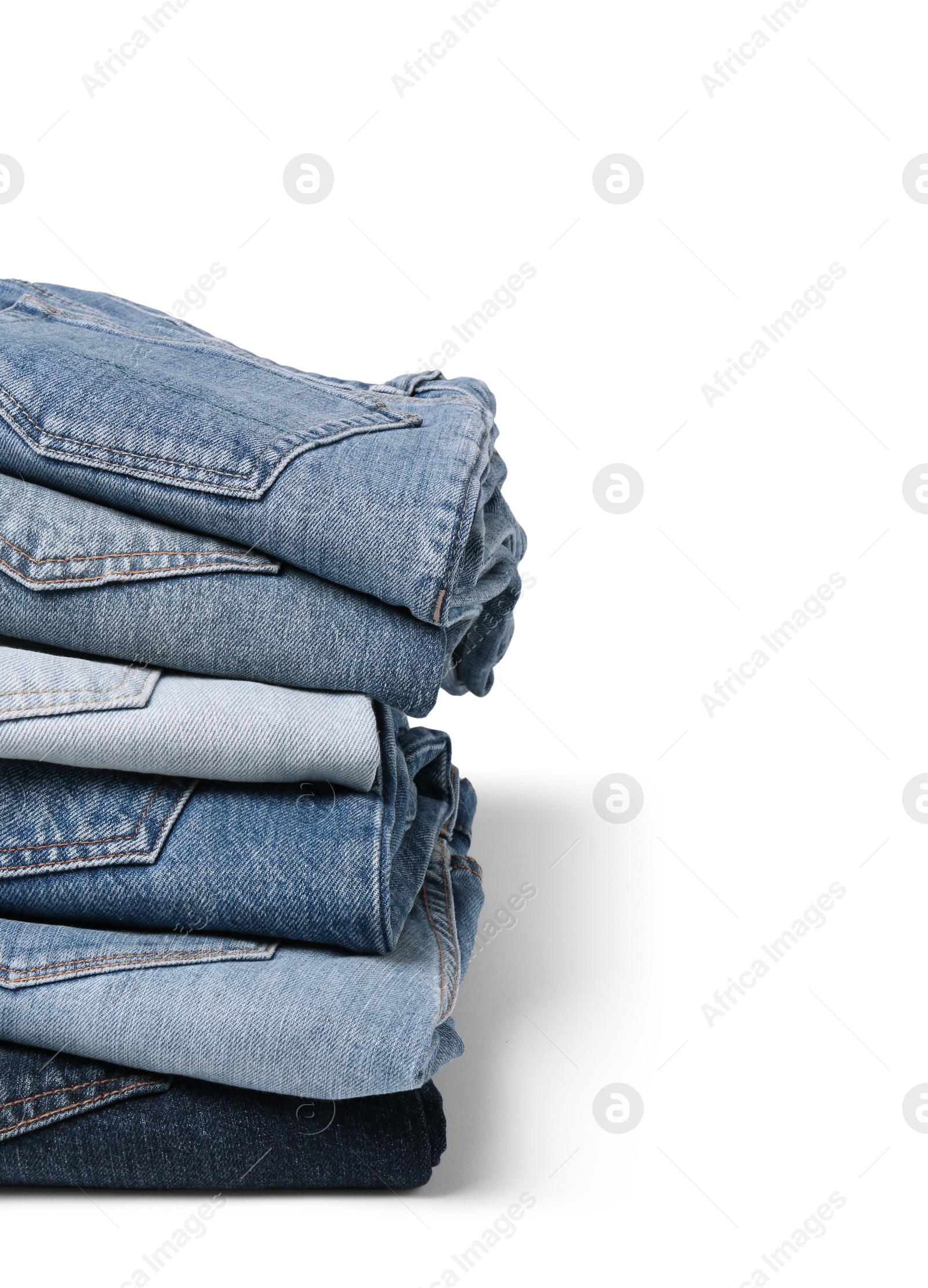 Image of Stack of different folded jeans isolated on white