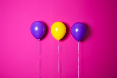 Different balloons on color background. Celebration time