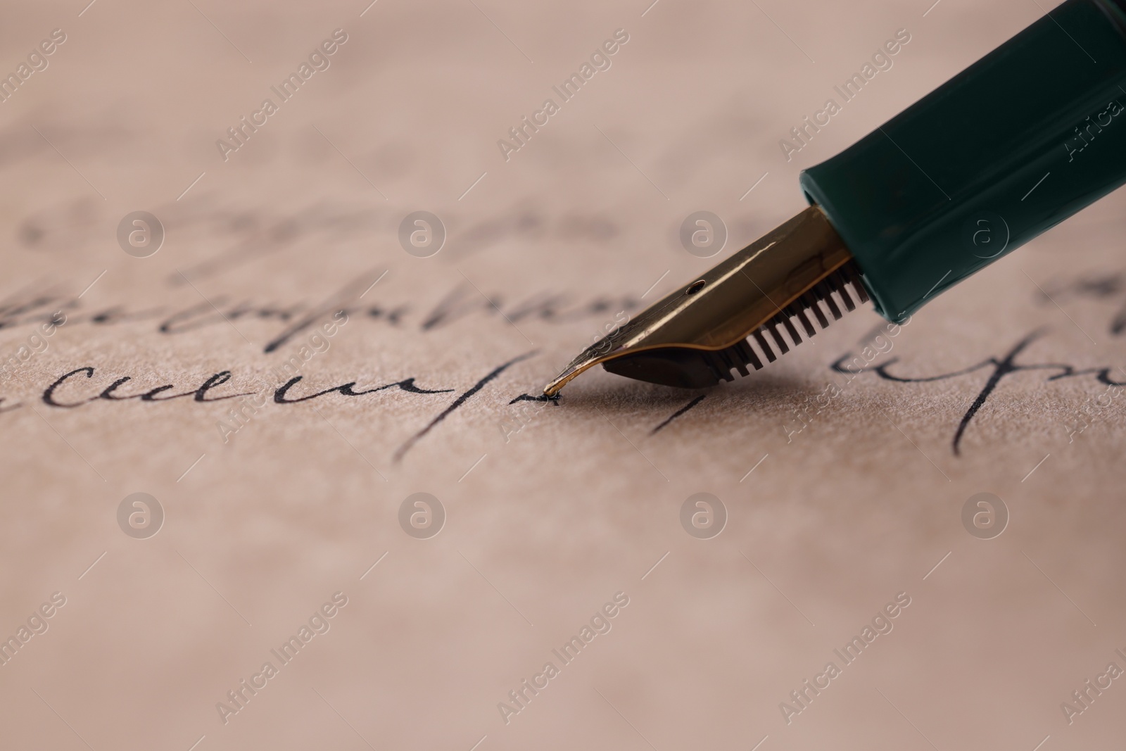 Photo of Writing letter with elegant fountain pen, closeup