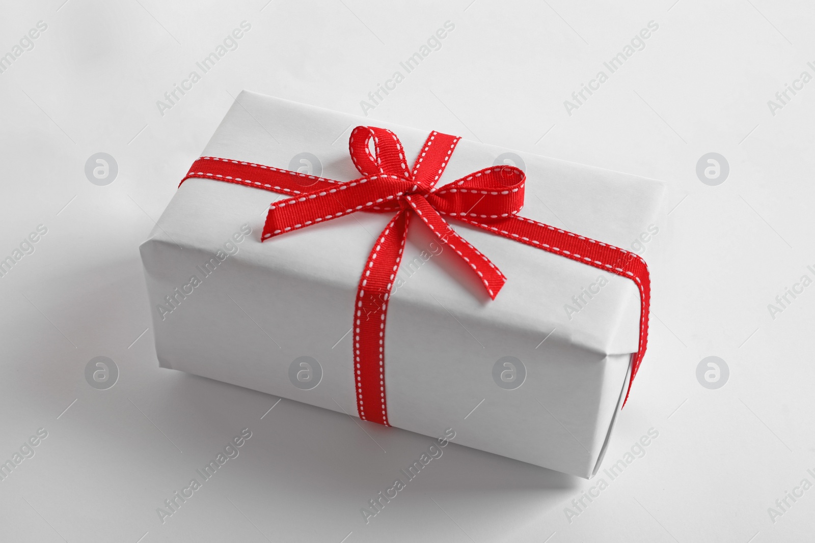 Photo of Beautifully wrapped gift box on white background