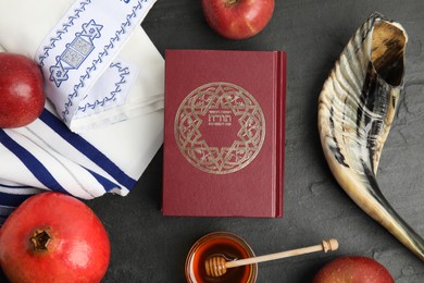 Photo of Flat lay composition with Rosh Hashanah holiday symbols on black table