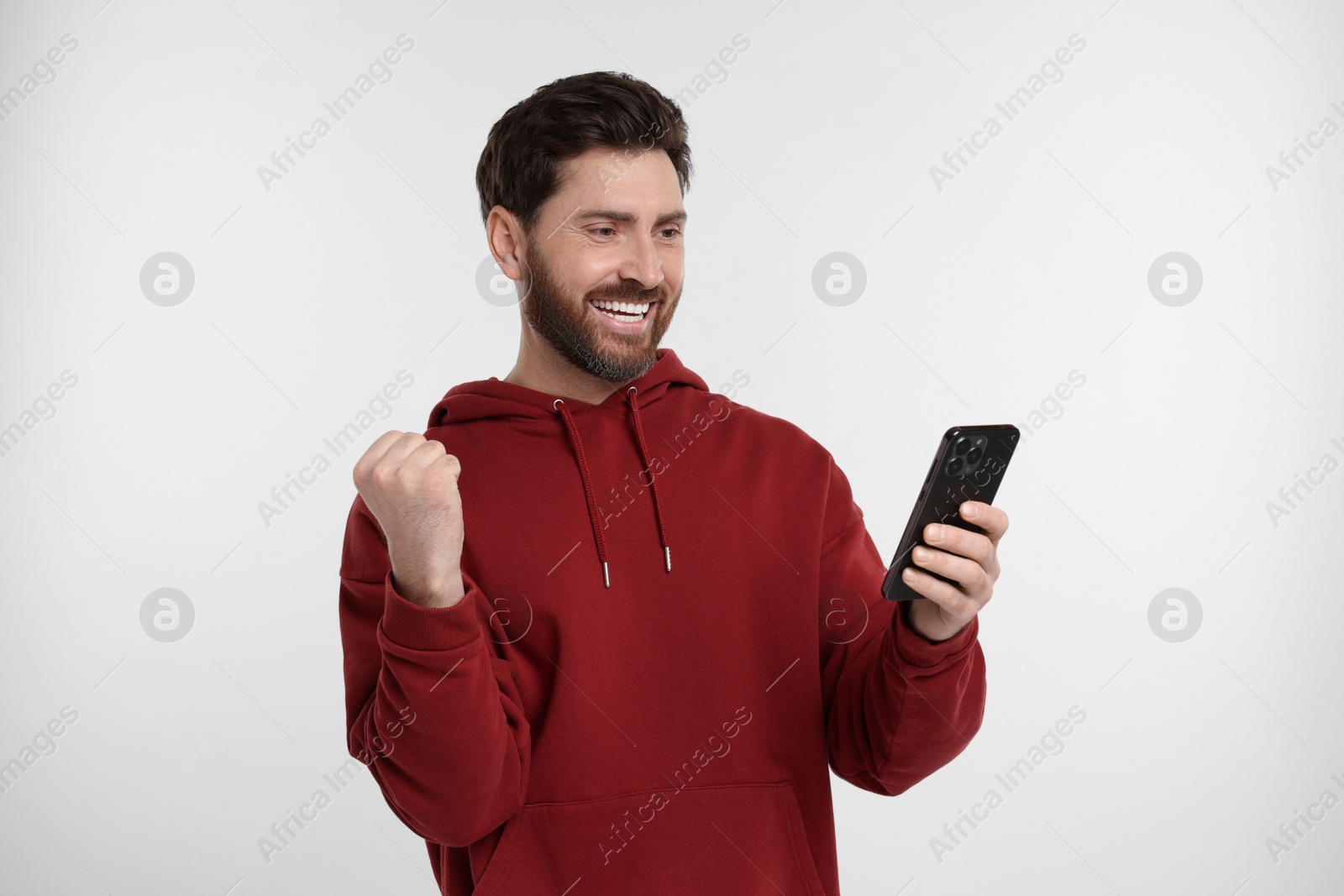 Photo of Happy man with smartphone on white background