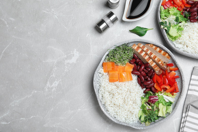 Photo of Tasty rice with beans served on light grey marble table, flat lay. Space for text