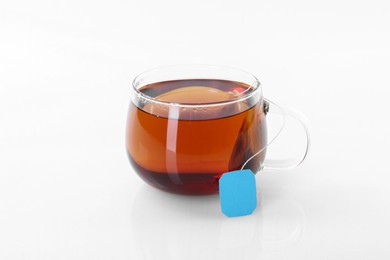 Tasty tea in cup on white background