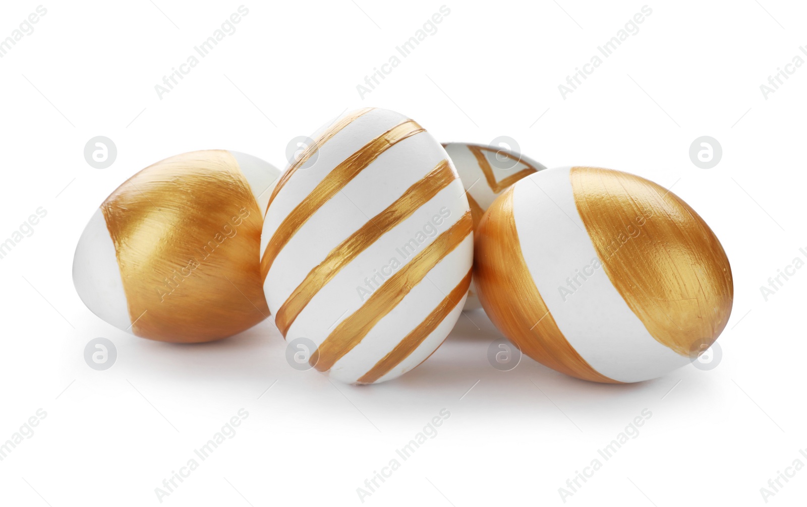 Photo of Set of traditional Easter eggs decorated with golden paint on white background