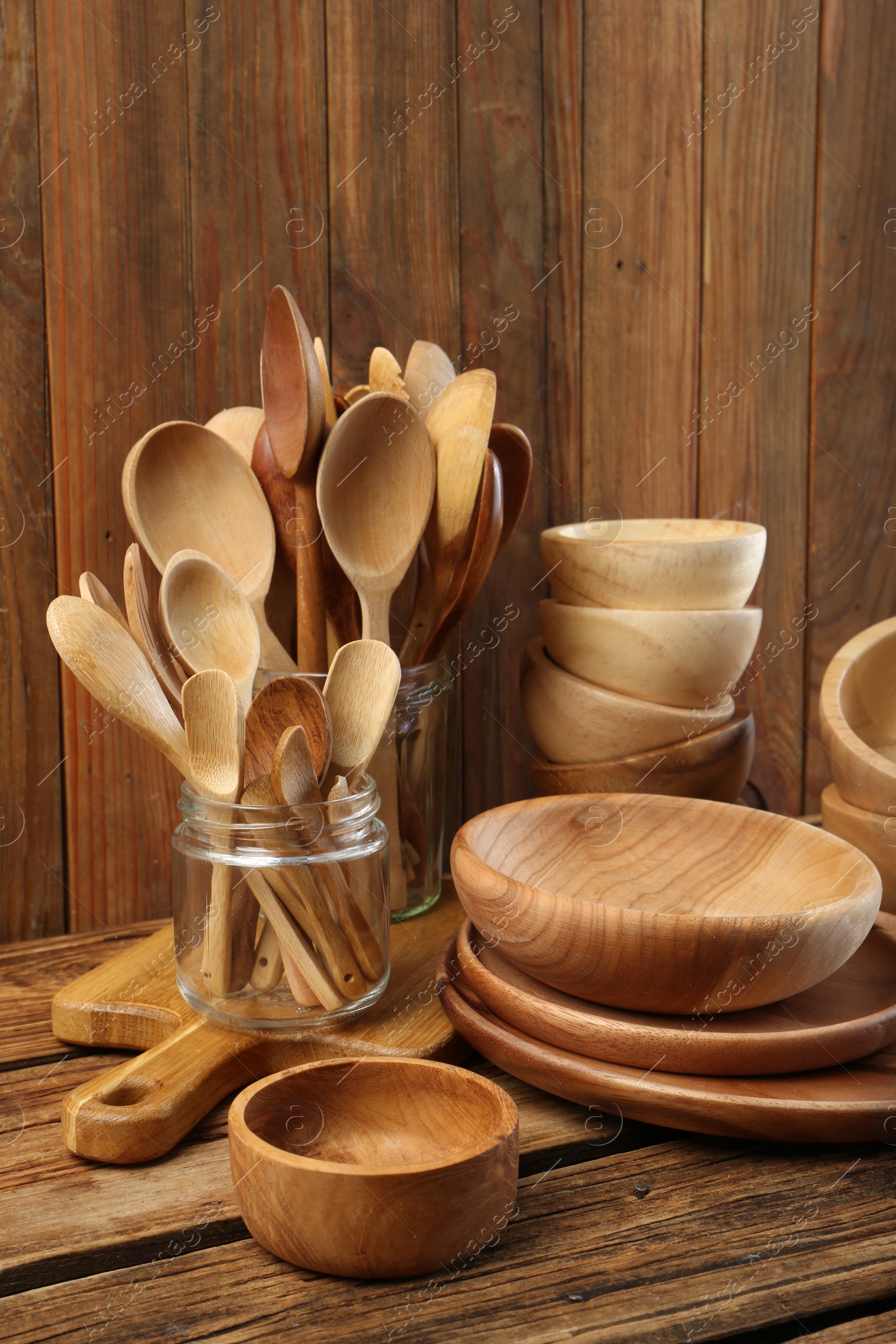 Photo of Many different wooden dishware and utensils on table