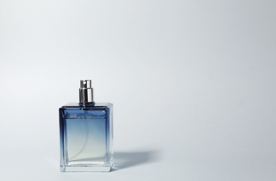 Photo of Bottle of perfume on light background