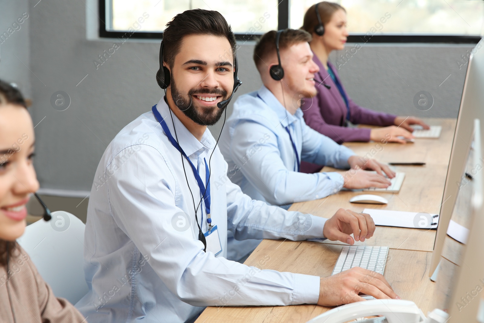 Photo of Technical support operator working with colleagues in office