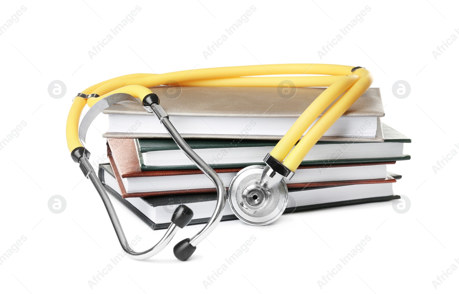 Photo of Stack of student textbooks and stethoscope on white background. Medical education