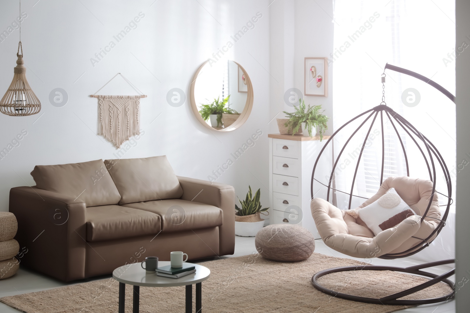 Photo of Stylish leather sofa and swing chair in modern living room interior