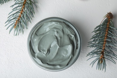 Photo of Professional face mask with spruce on white table, flat lay