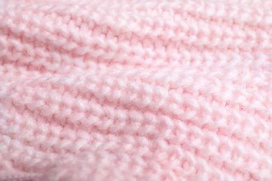 Photo of Pink knitted sweater as background, closeup view