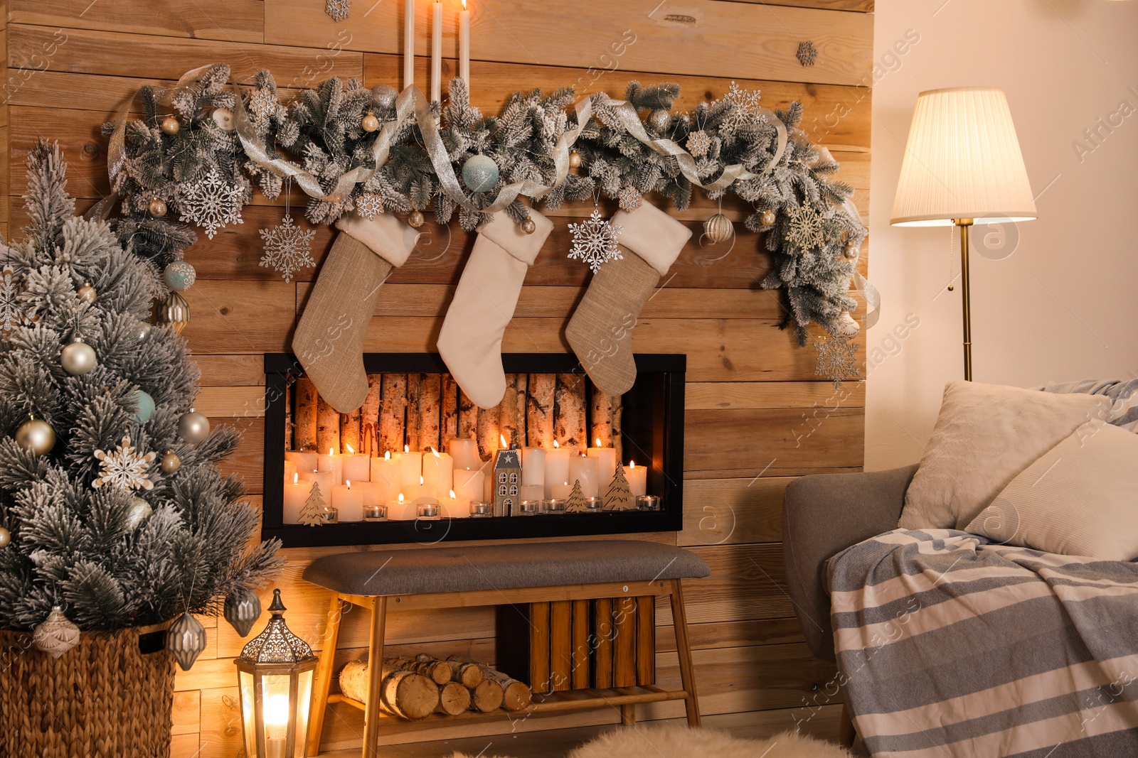 Photo of Festive room interior with decorative fireplace and Christmas stockings