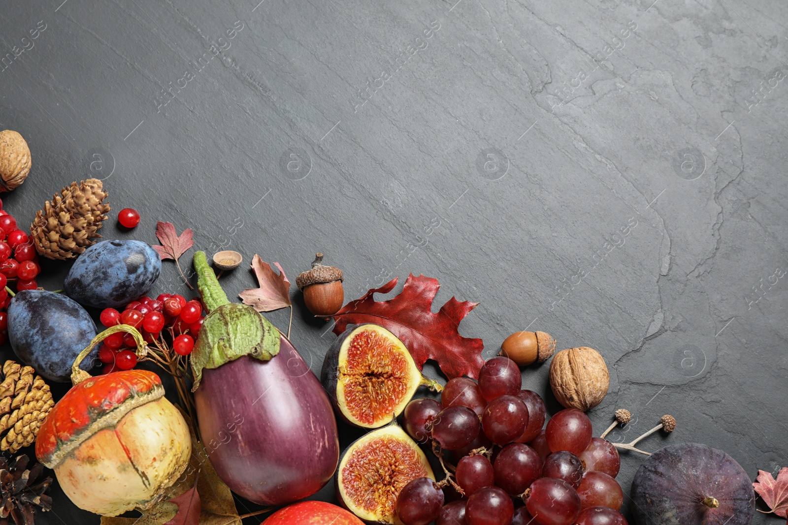 Photo of Flat lay composition with autumn vegetables and fruits on grey background, space for text. Happy Thanksgiving day