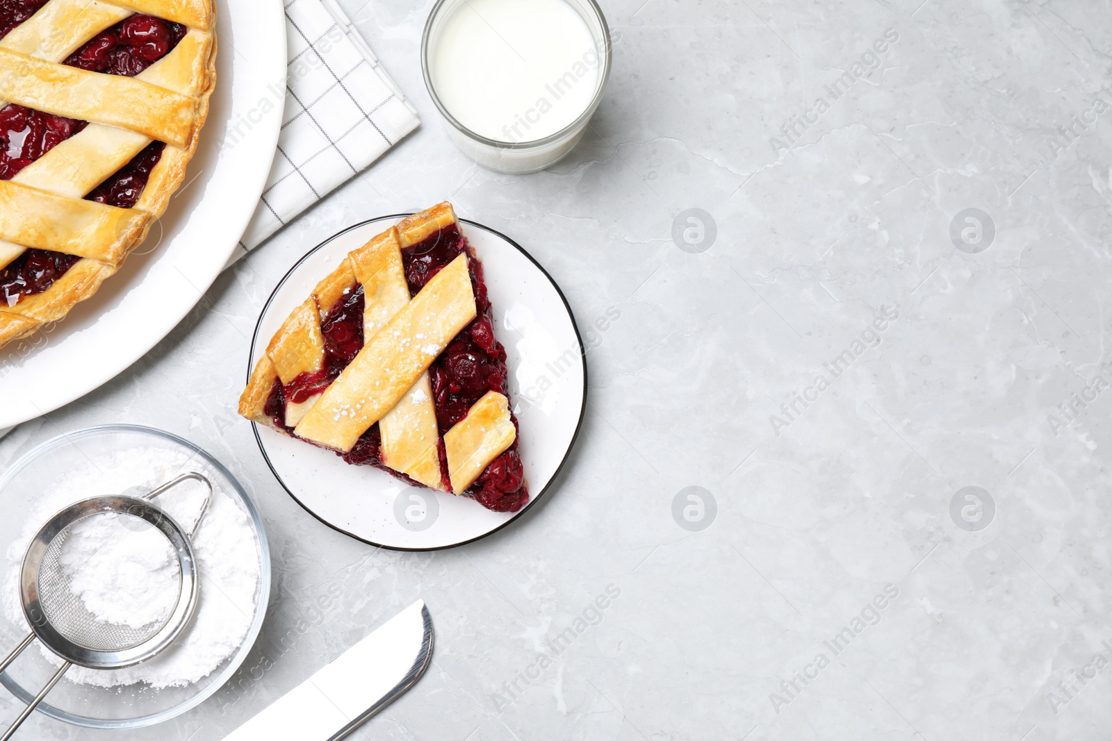 Photo of Delicious fresh cherry pie on light grey marble table, flat lay. Space for text