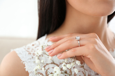 Young bride wearing beautiful engagement ring, closeup