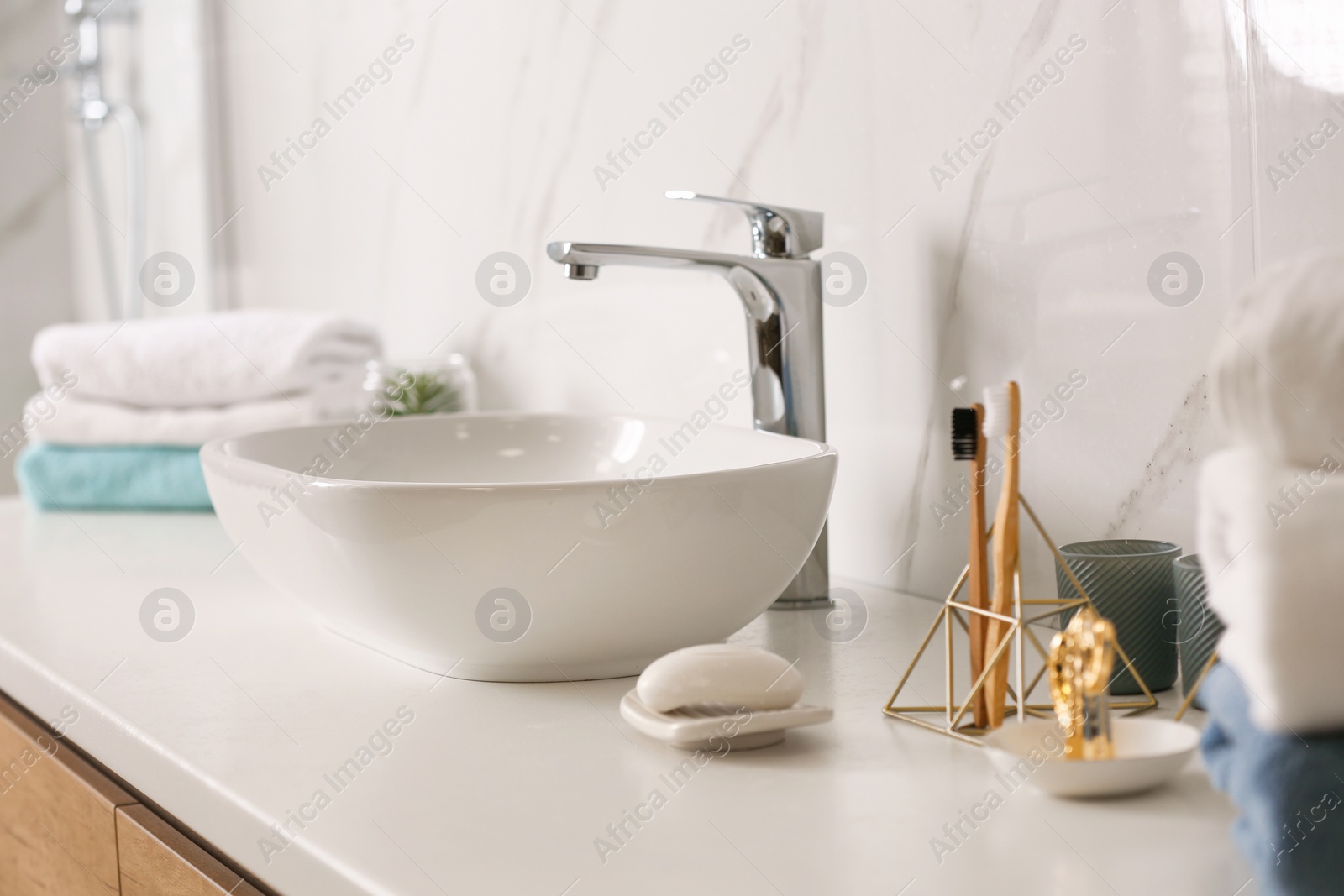 Photo of Stylish vessel sink on light countertop in modern bathroom