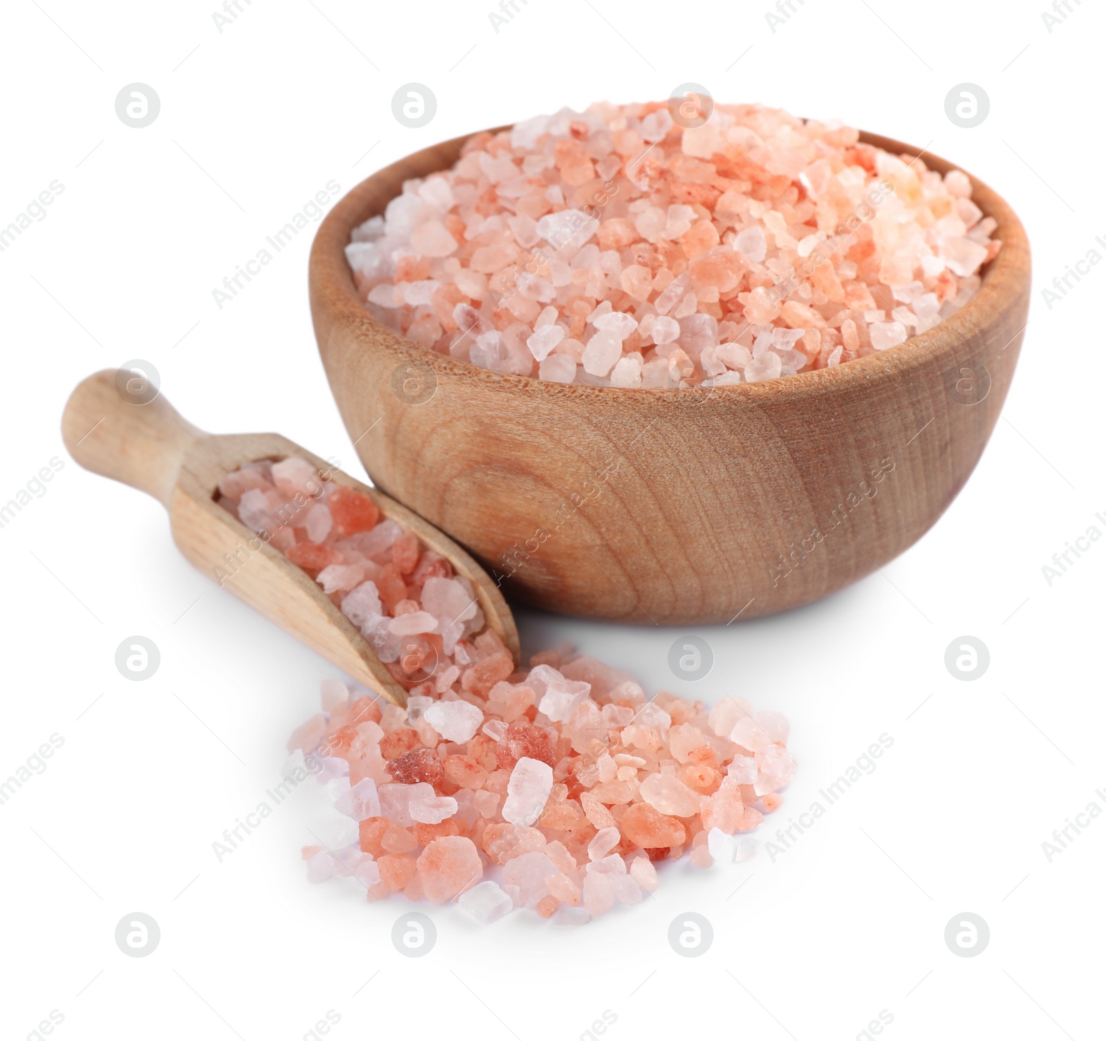 Photo of Wooden bowl and scoop with pink salt on white background