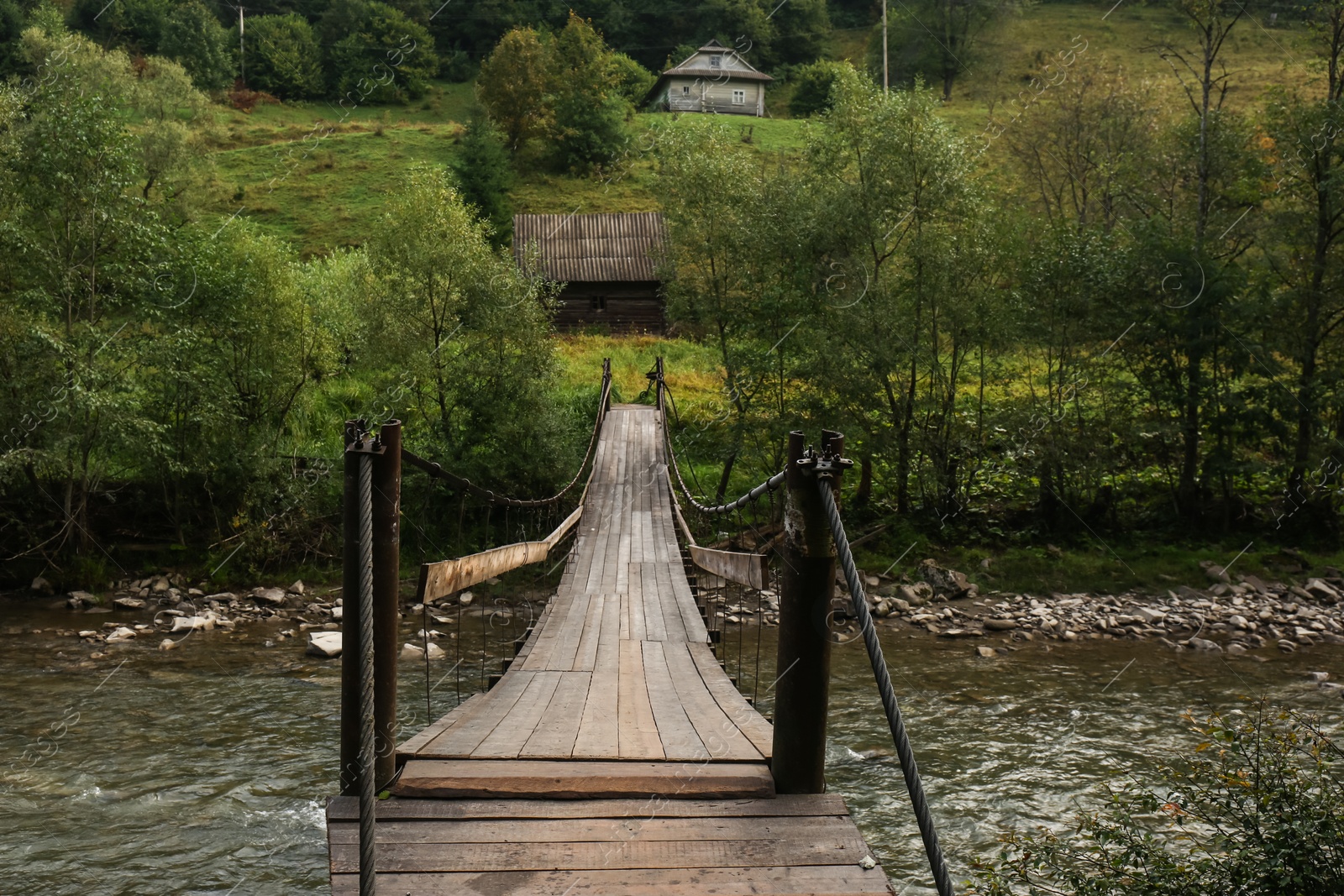 Photo of Beautiful view of wooden bridge over river