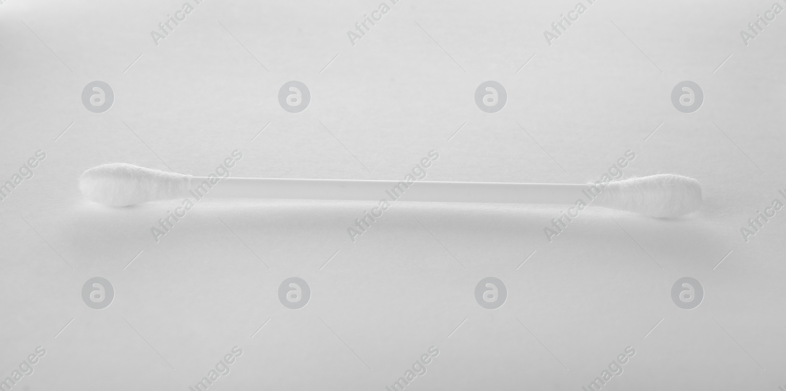 Photo of Clean cotton bud isolated on white. Hygienic accessory