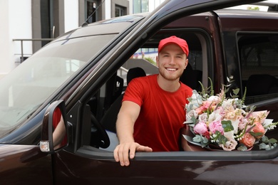 Delivery man with beautiful flower bouquet leaving car