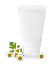 Tube of hand cream and chamomiles on white background
