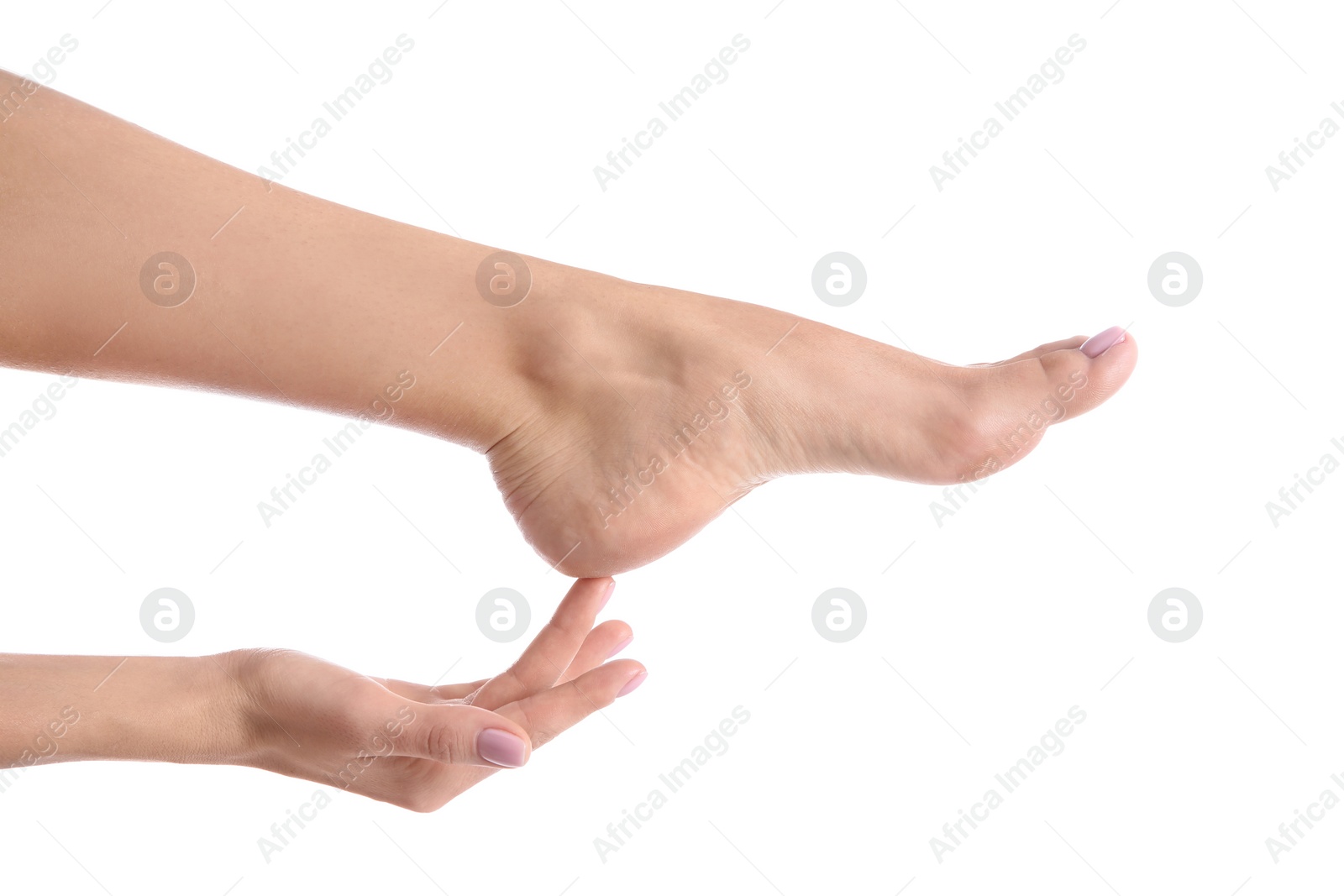 Photo of Woman touching her foot on white background, closeup. Spa treatment