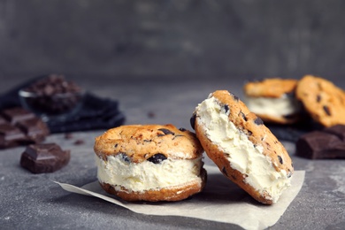 Photo of Sweet delicious ice cream cookie sandwiches on table