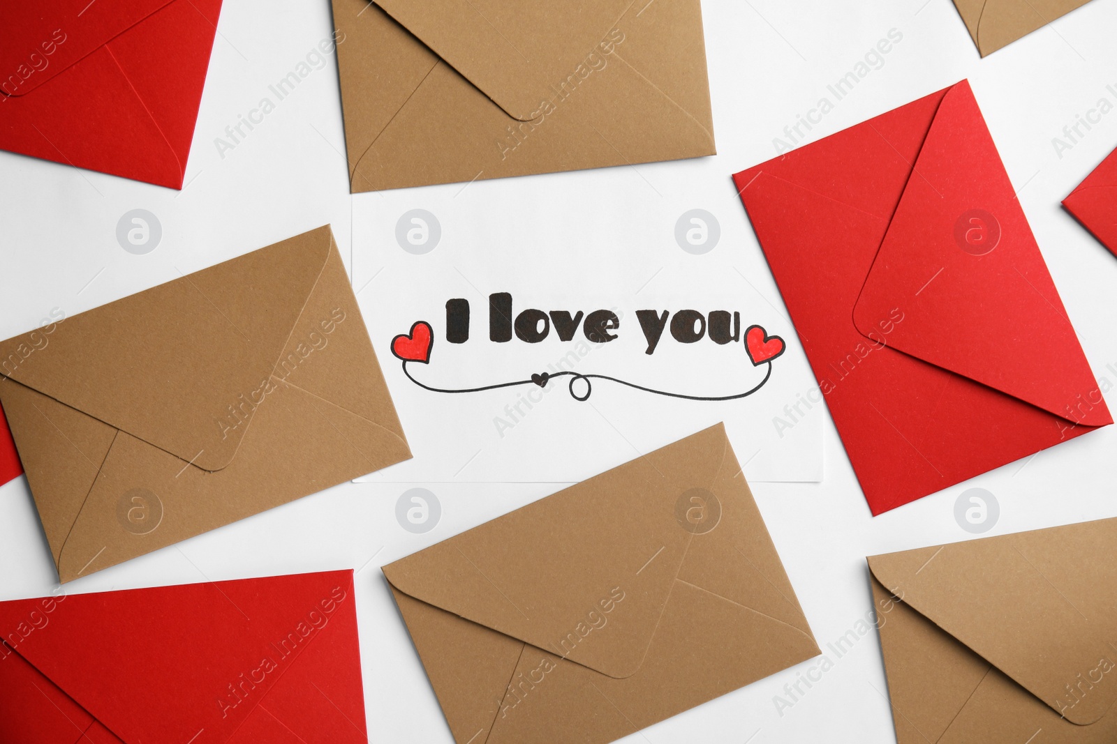 Photo of Card with phrase I Love You and envelopes on white background, flat lay