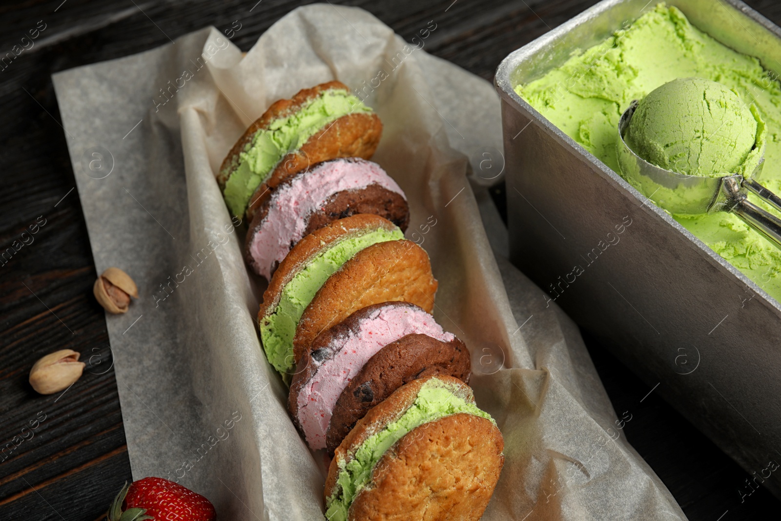 Photo of Different sweet delicious ice cream cookie sandwiches served on table