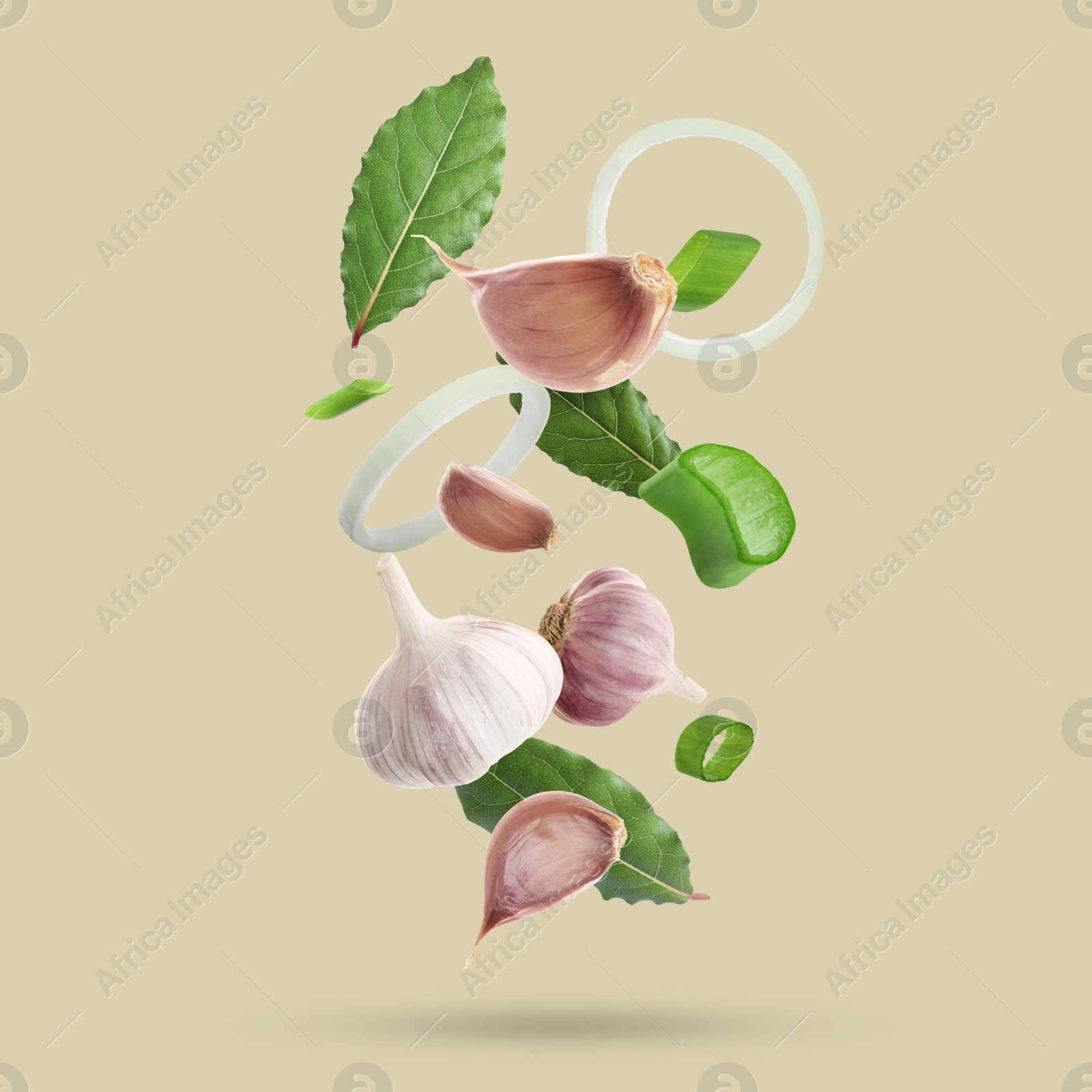 Image of Different spices falling on dark beige background