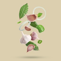 Image of Different spices falling on dark beige background