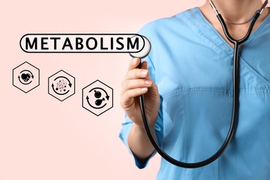 Image of Metabolism concept. Doctor with stethoscope on light background, closeup