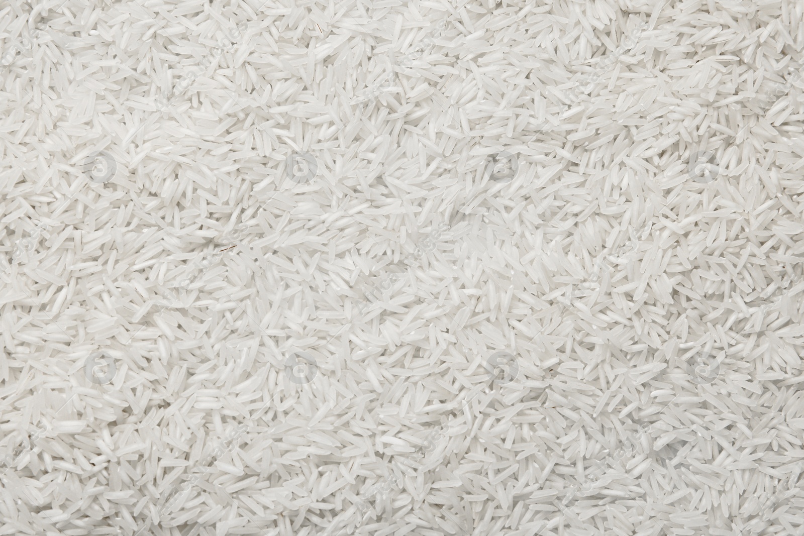 Photo of Raw basmati rice as background, top view