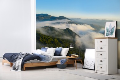 Image of Light bedroom. Interior with comfortable bed and mountain landscape wallpapers